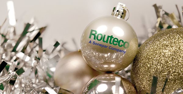 Gold baubles with Routeco's logo on. Silver tinsel is in the background